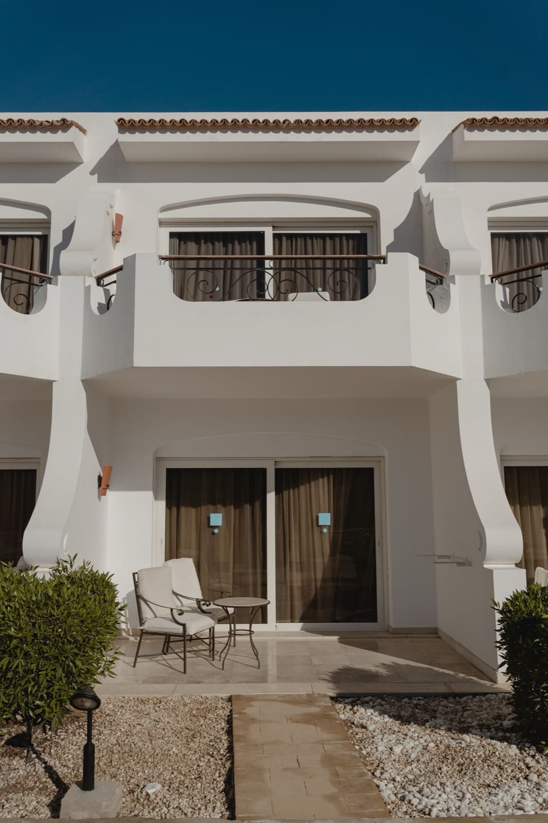 Contemporary villa with balcony and patio under a clear sky