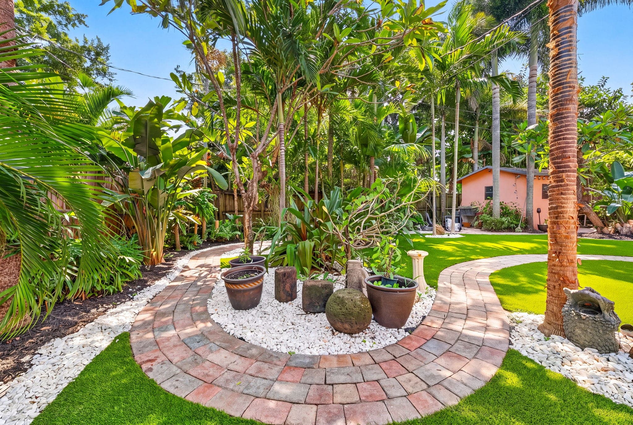 Circular paver patio with planters set in white rock