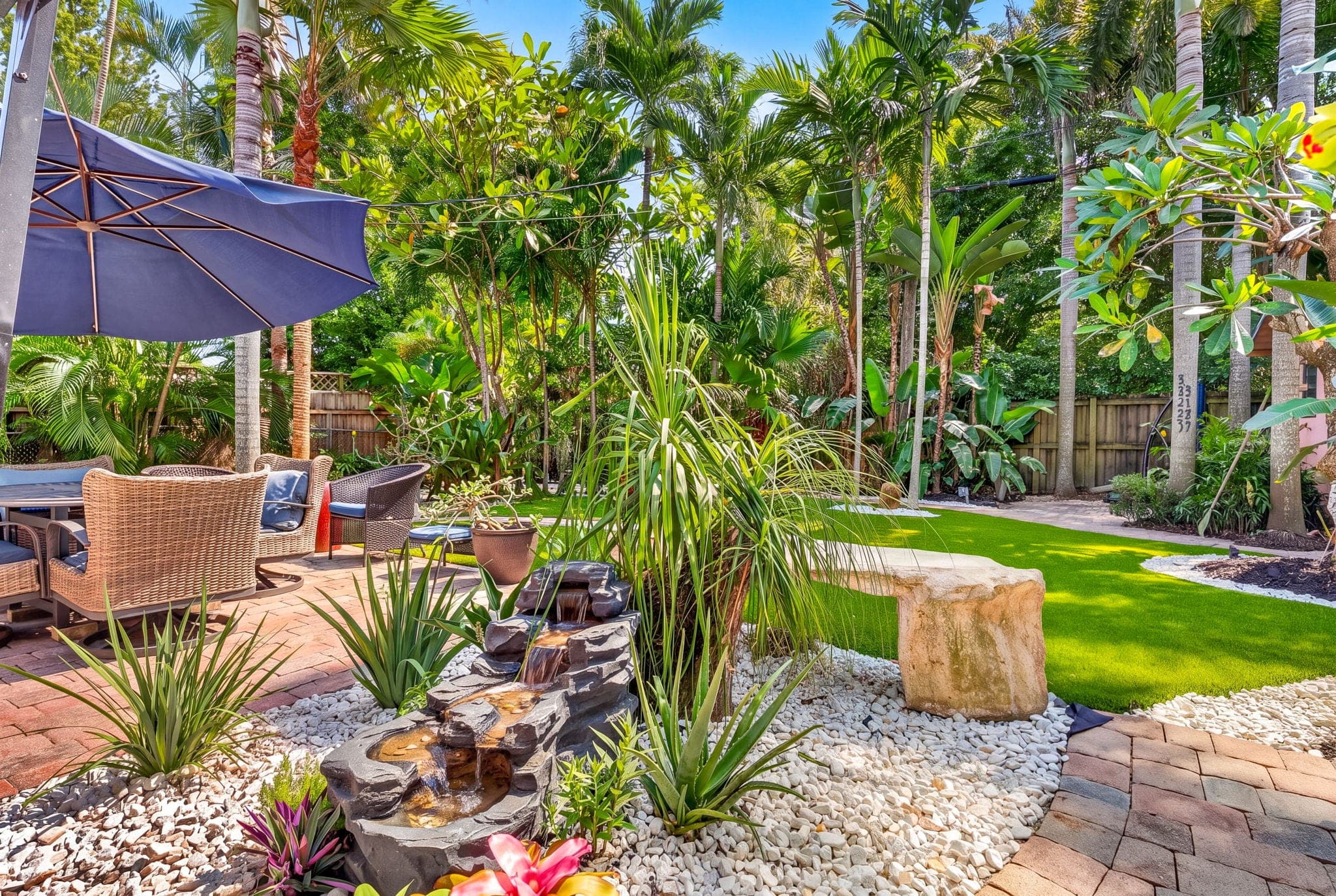 Tiered fountain and rock bed beside the patio seating