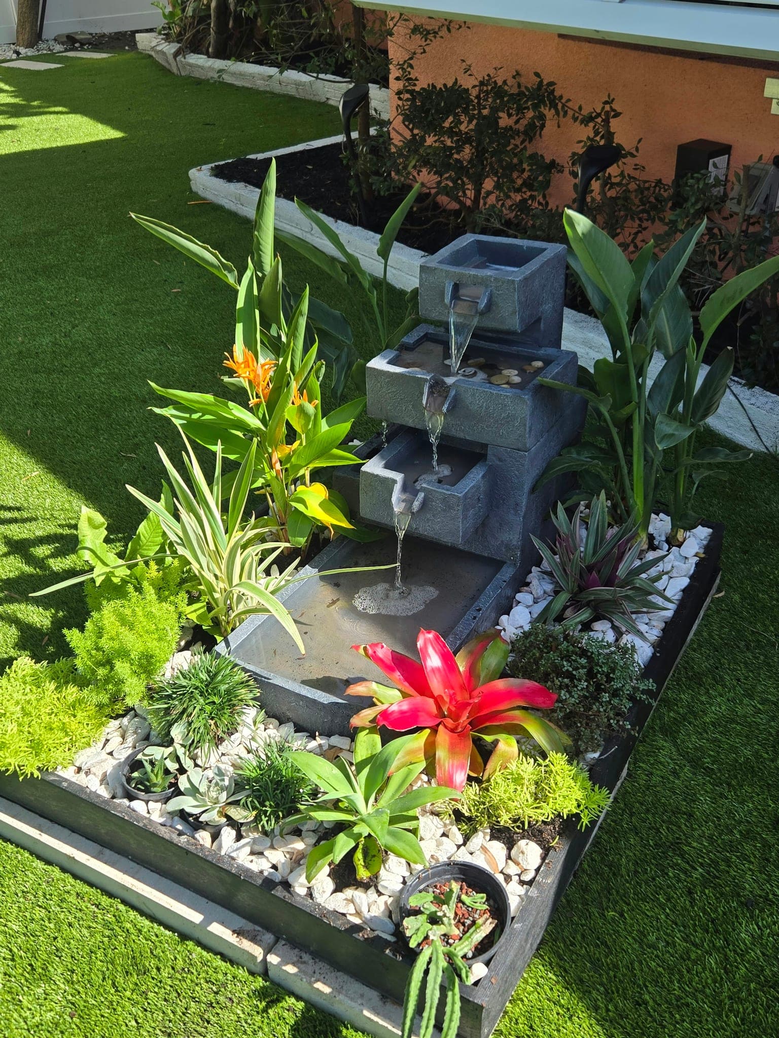 Fountain planter with bromeliads on the new turf