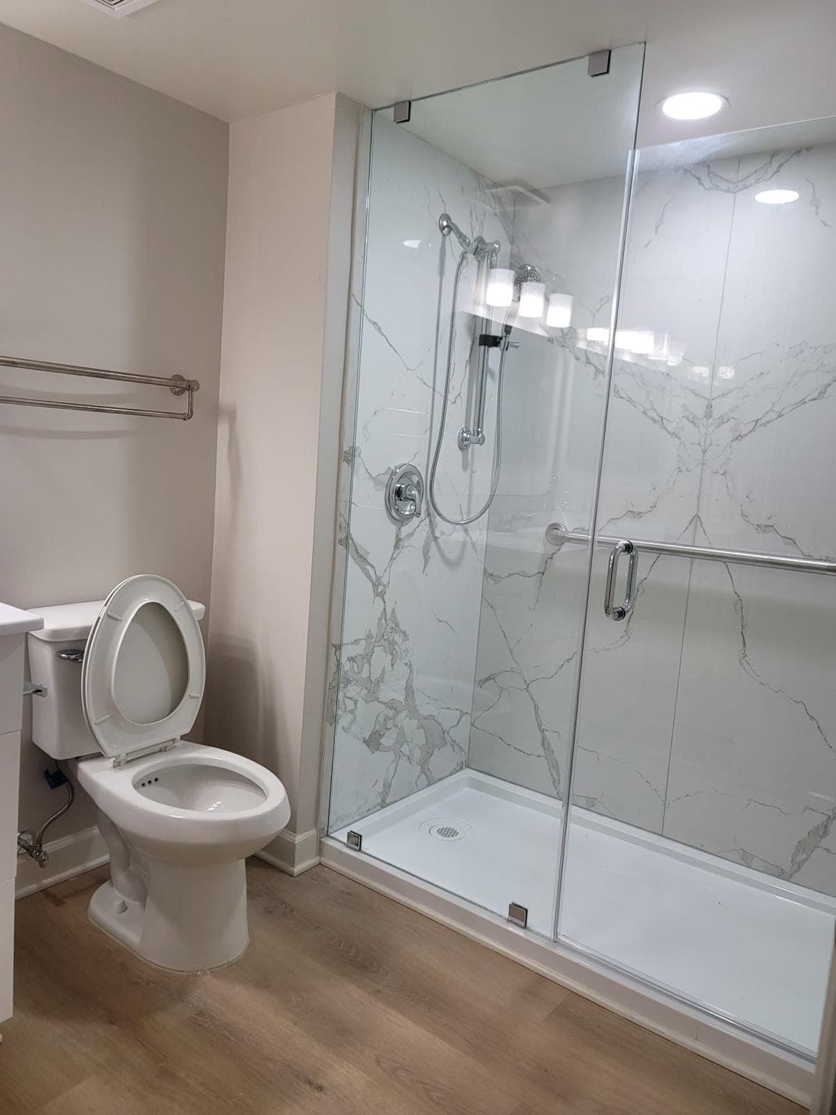 Walk-in shower with sliding glass door and shower base