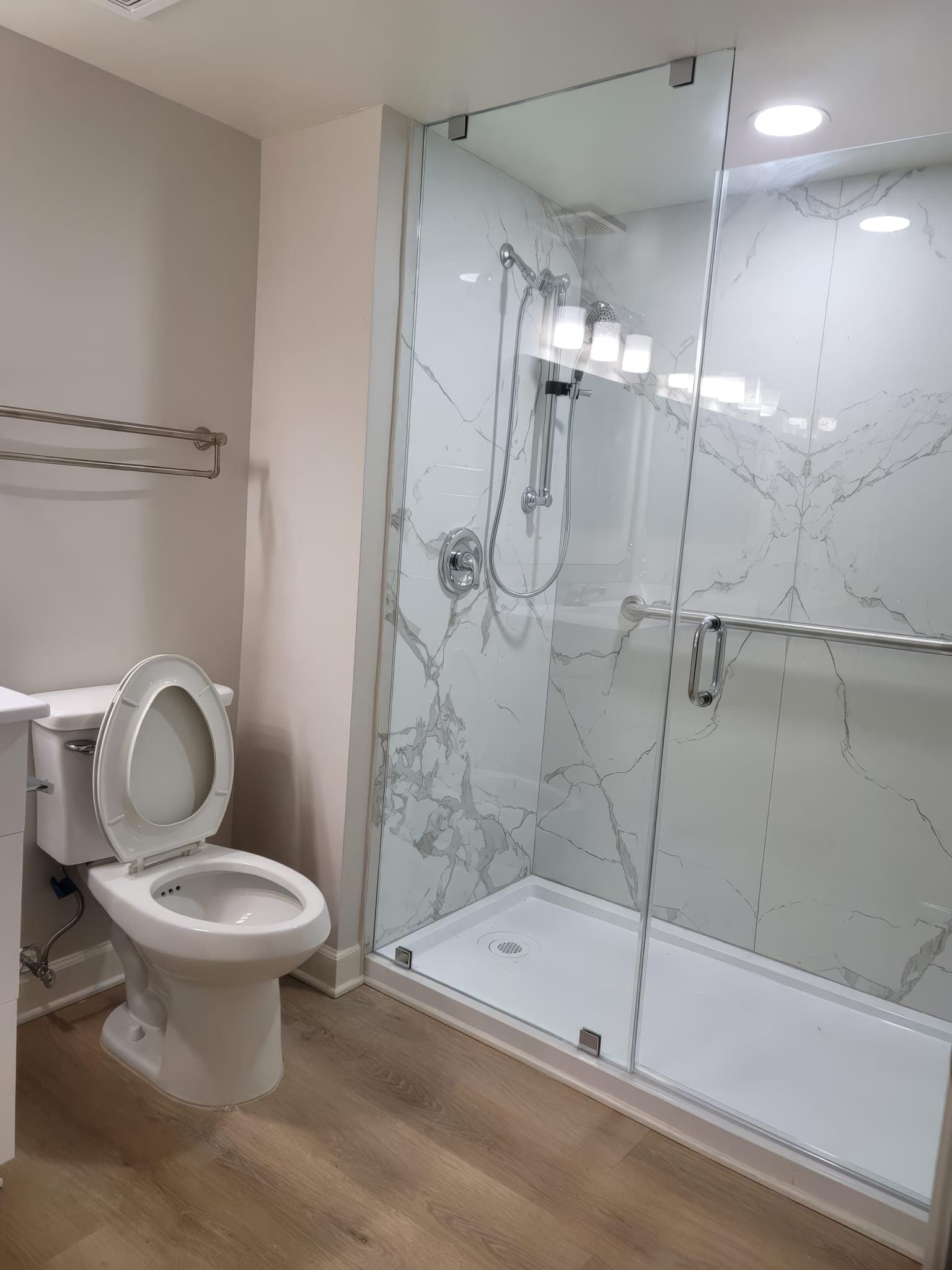 Walk-in shower with sliding glass door and shower base