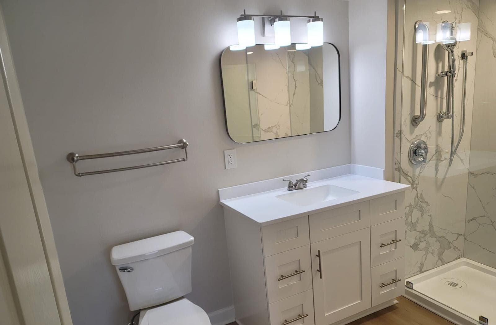 Vanity, toilet and shower in a remodeled bathroom