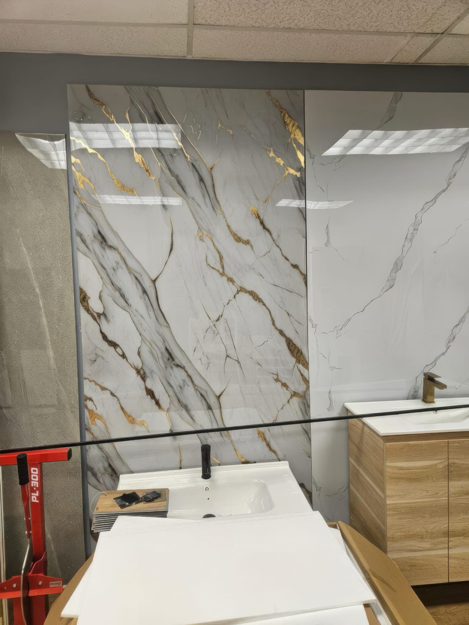 Book-matched marble-look porcelain shower wall with gold veining