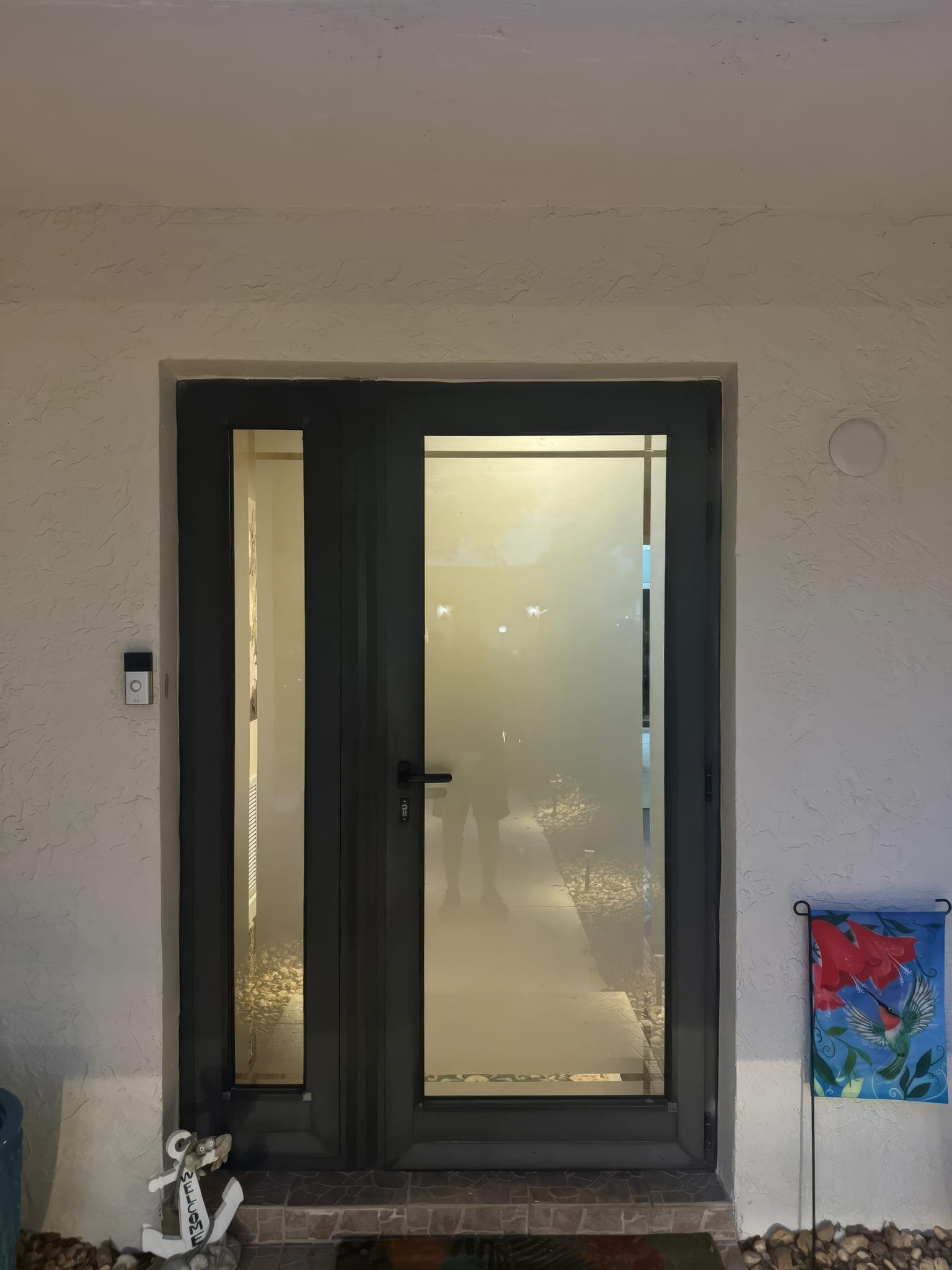 Impact entry door closed, with the frosted sidelite and new hardware