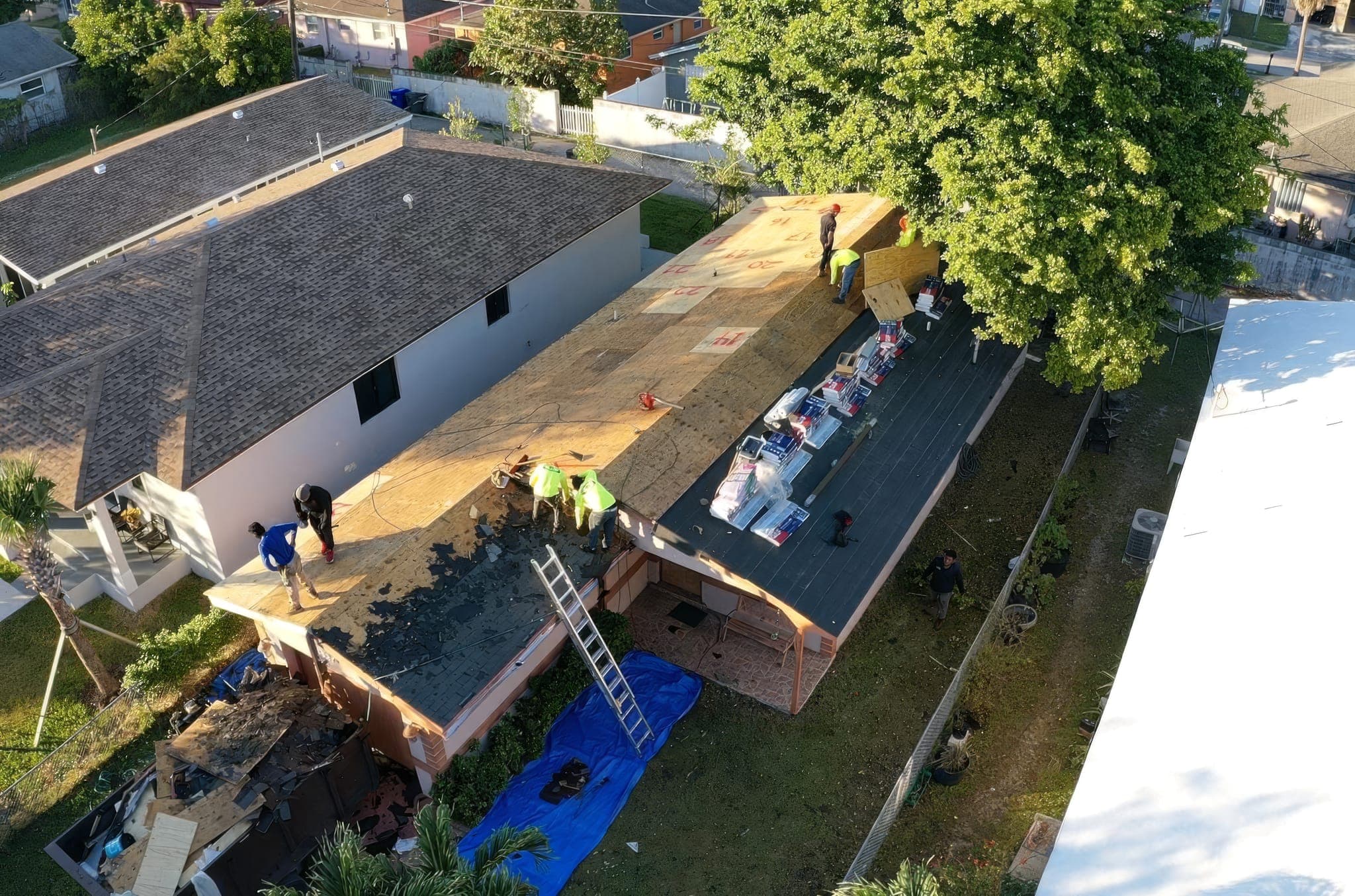 Drone view of the dried-in roof deck with the crew working along the ridge