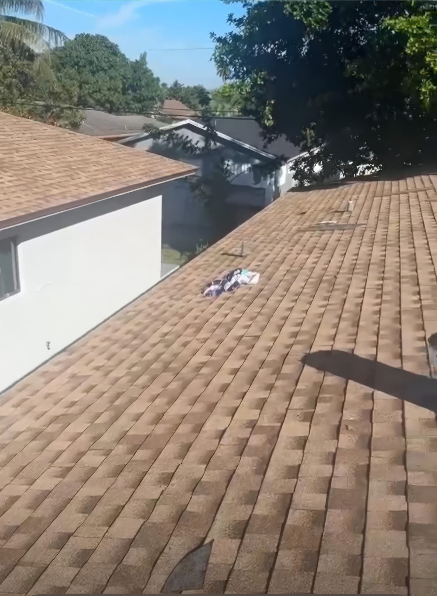 New brown architectural shingle roof, finished and swept clean