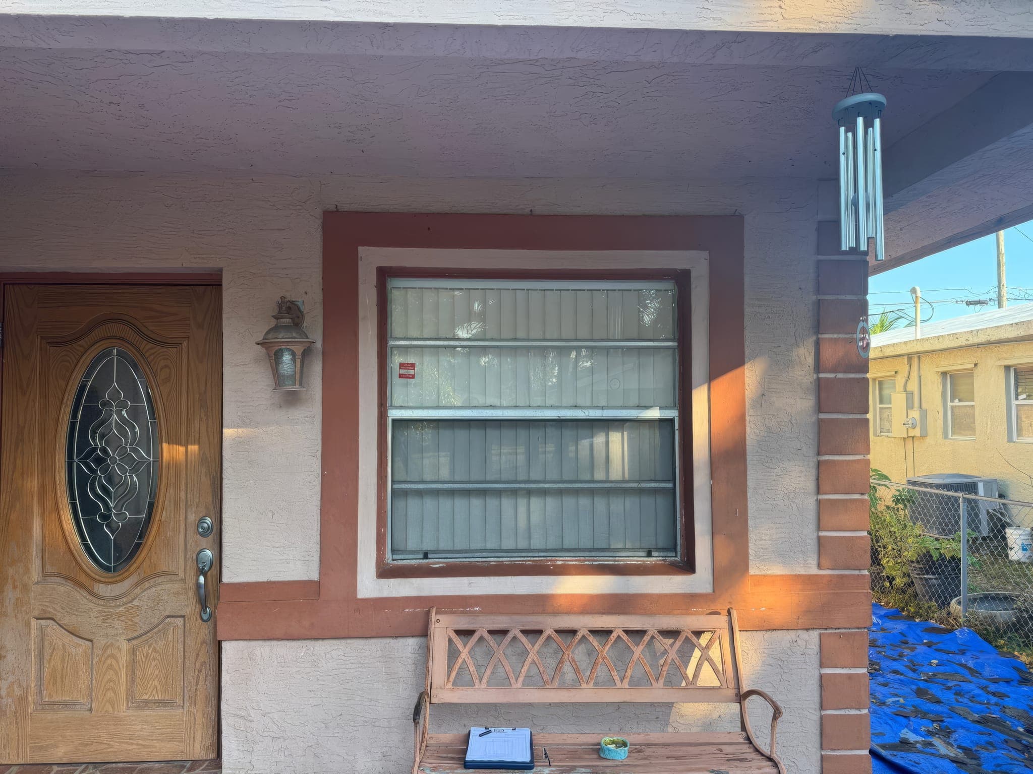 Front entry with the original single-pane window beside the door before replacement