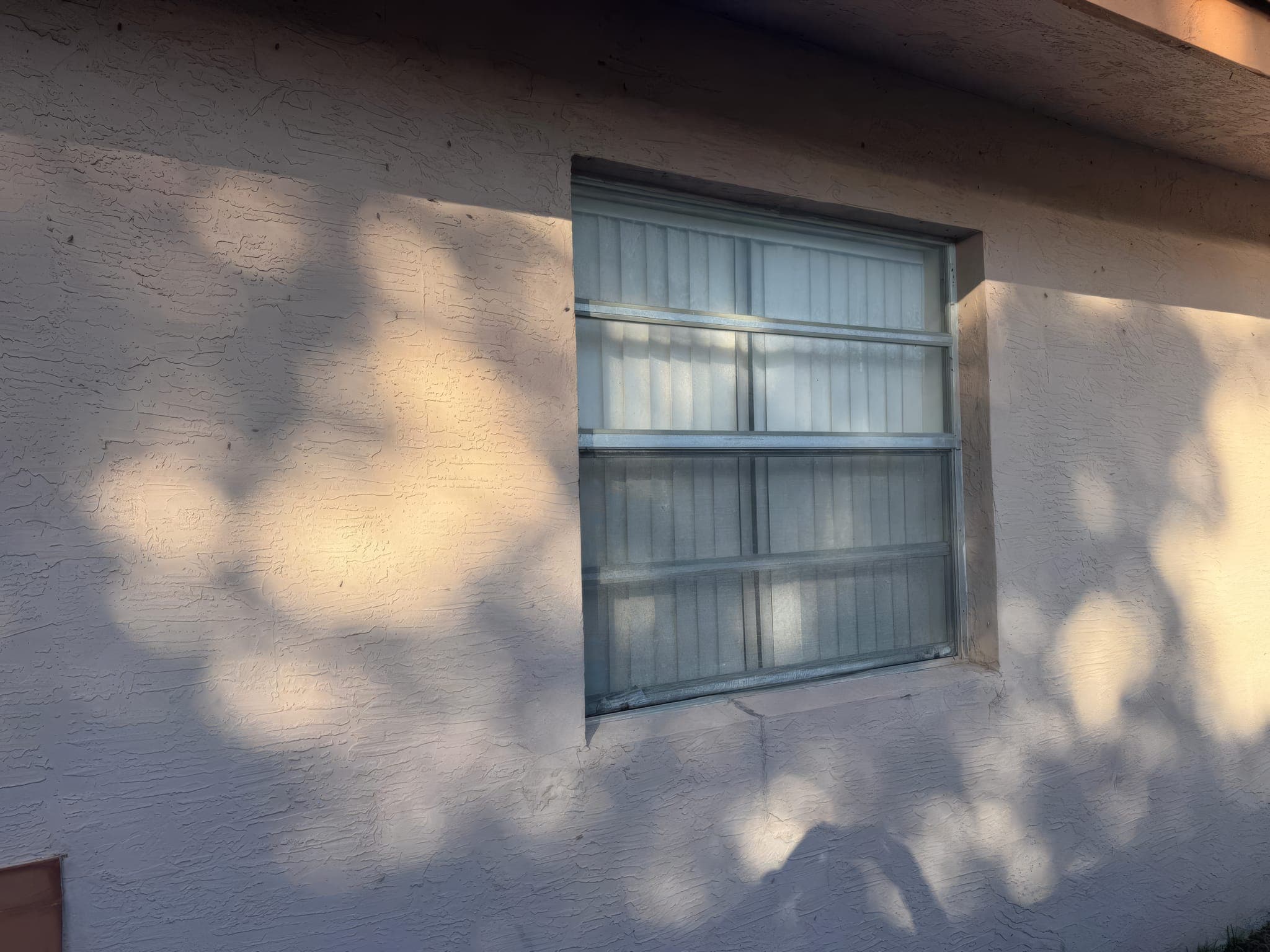 Original jalousie window on the side of the house before replacement