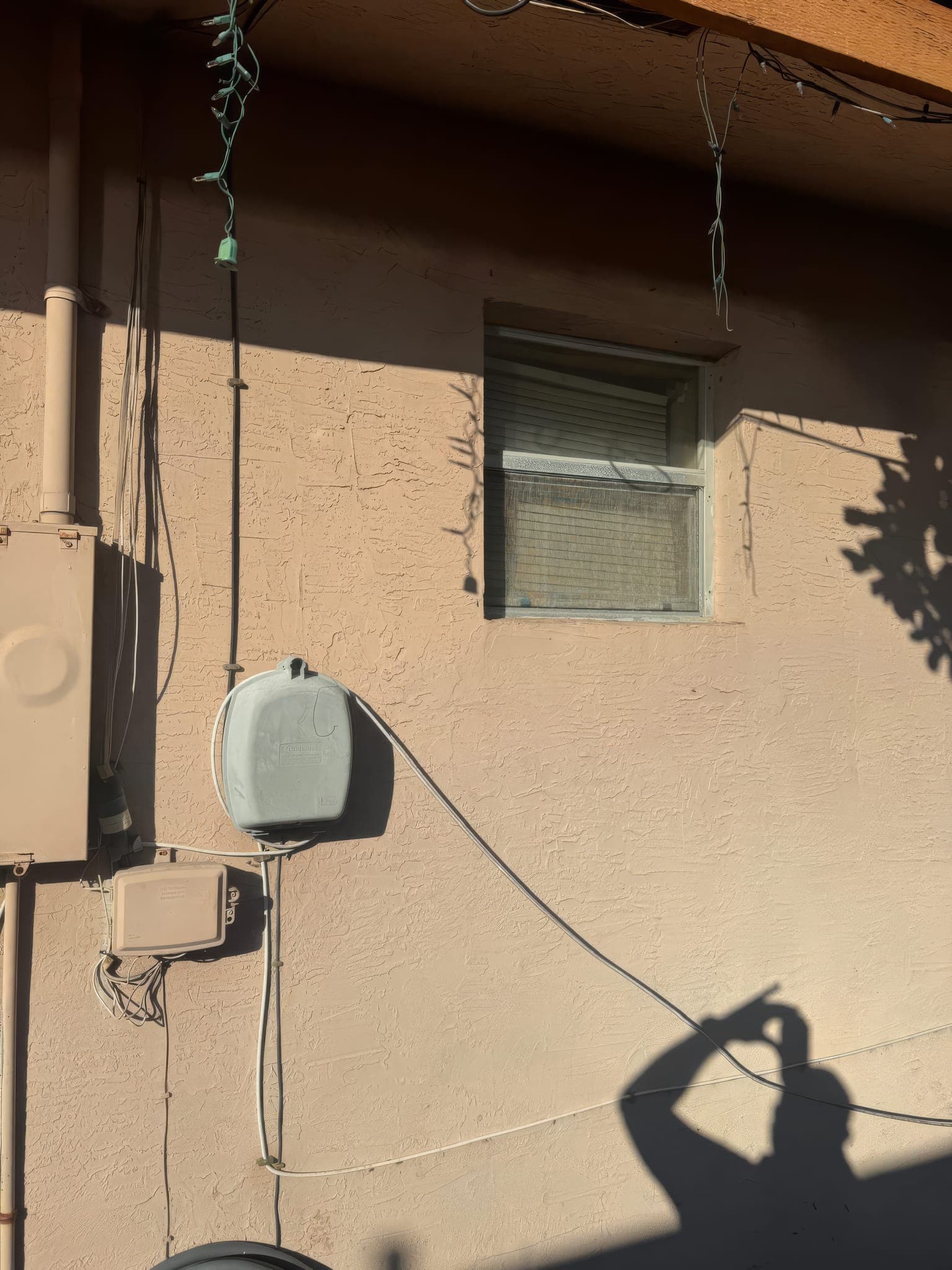 Small original window and exterior wiring documented before the window swap