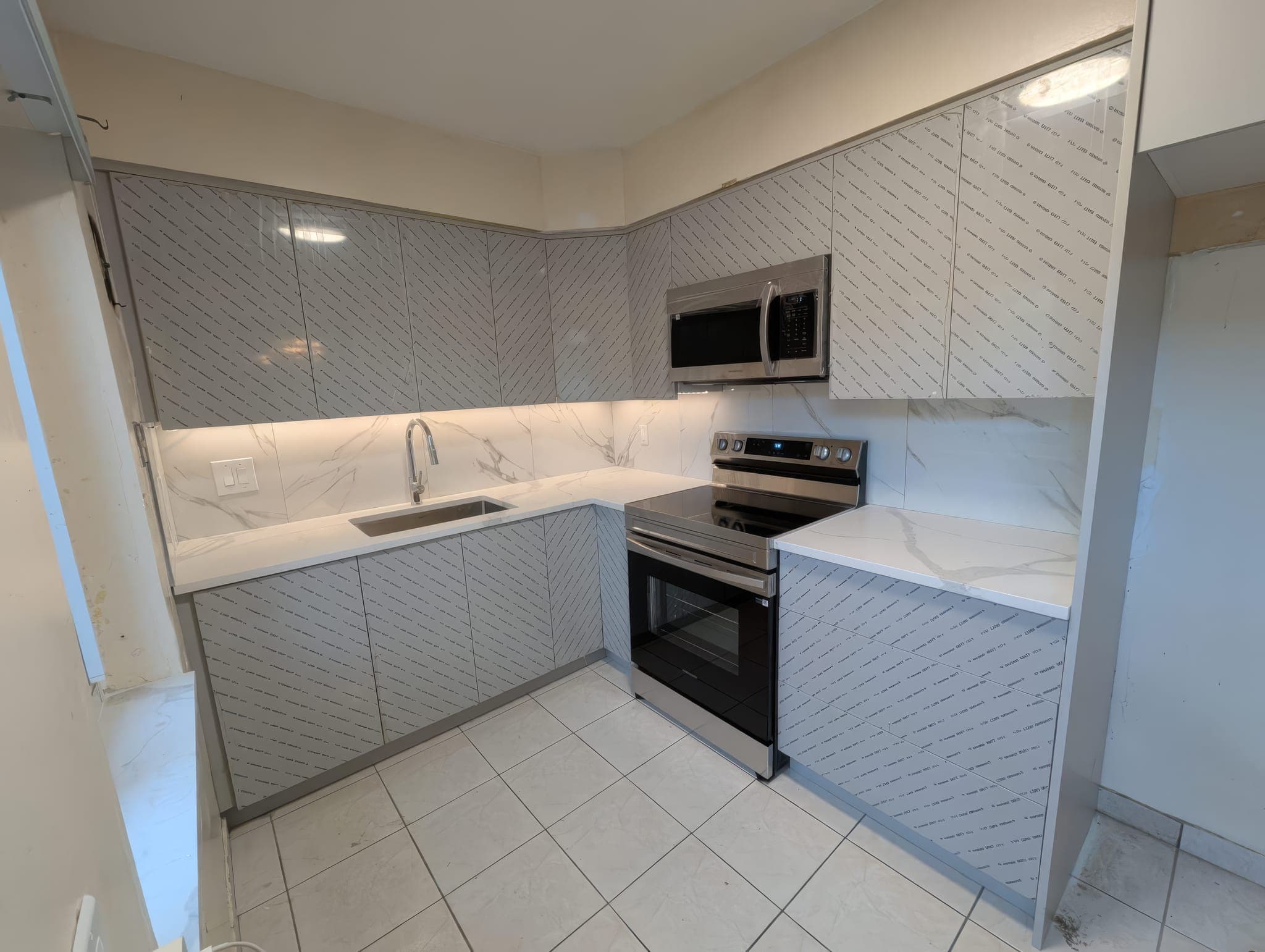 Kitchen corner with new stainless range and under-cabinet lighting