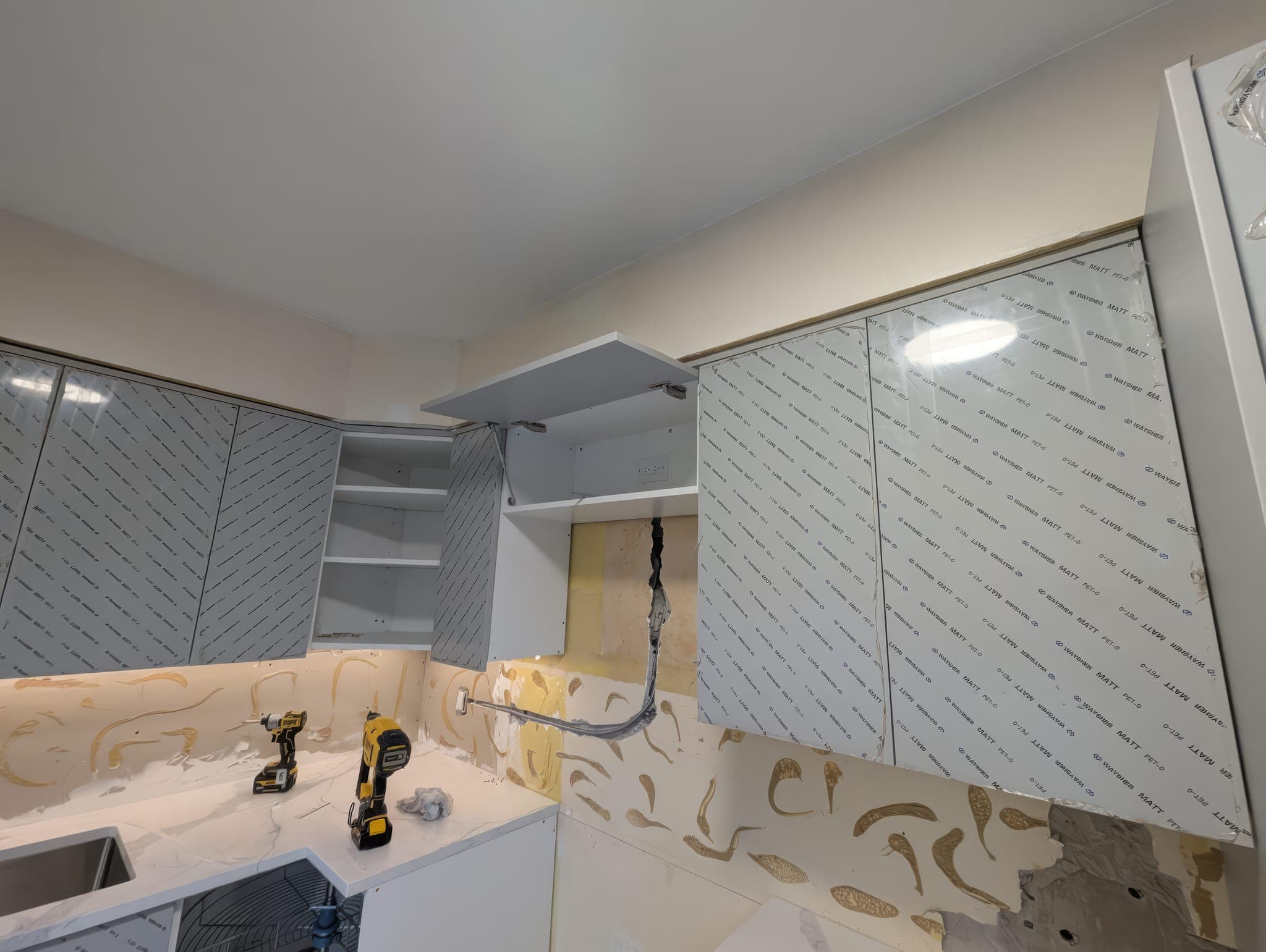 Cabinet boxes installed before counters and backsplash