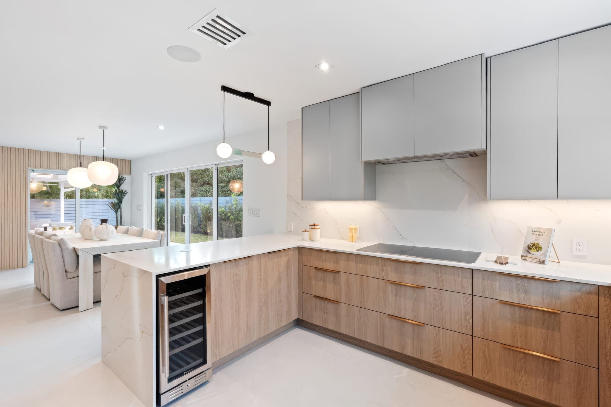 Modern kitchen with grey upper cabinets, walnut lower cabinets and built-in wine cooler