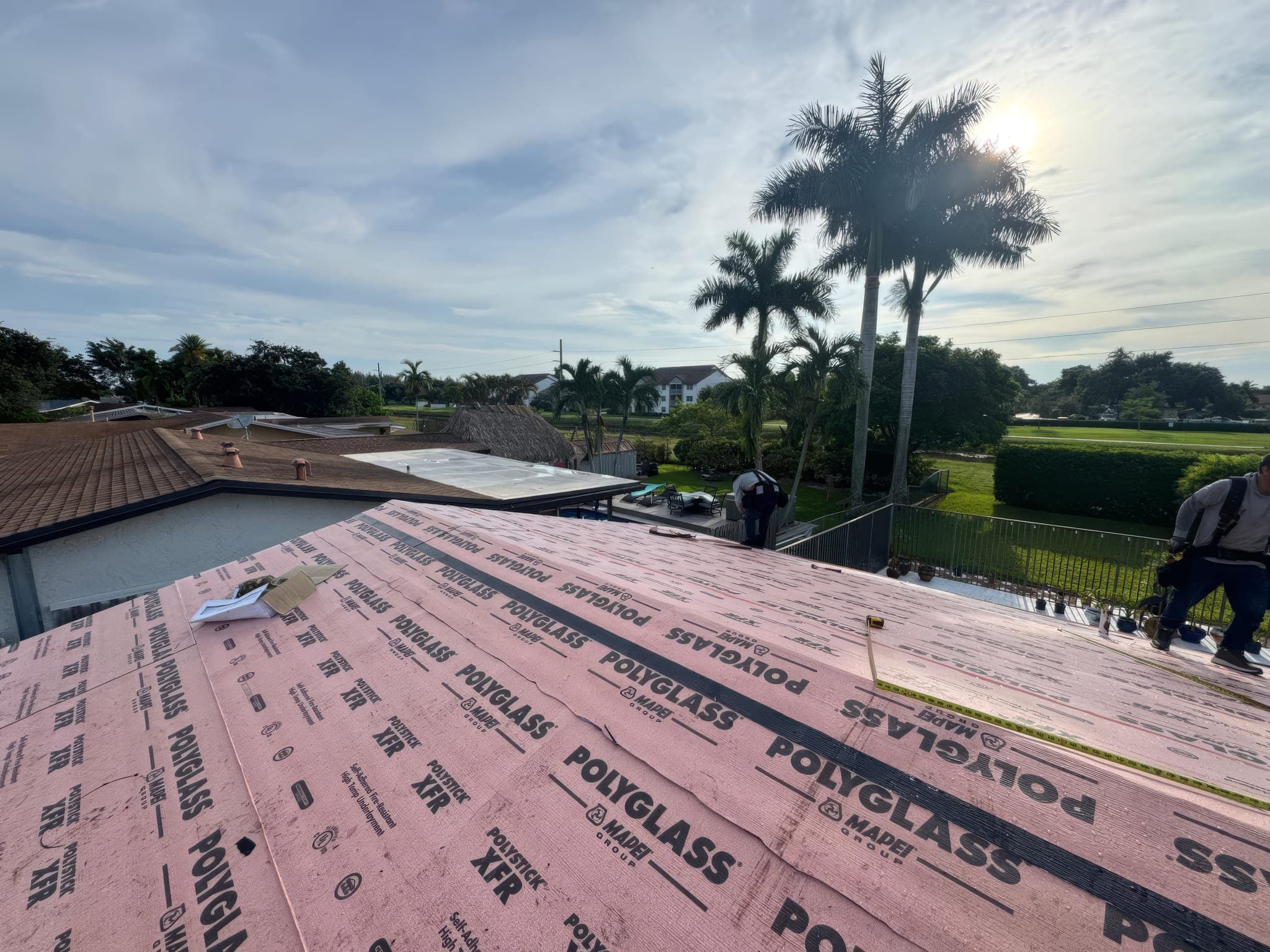 Crew on the dried-in roof deck before panel installation