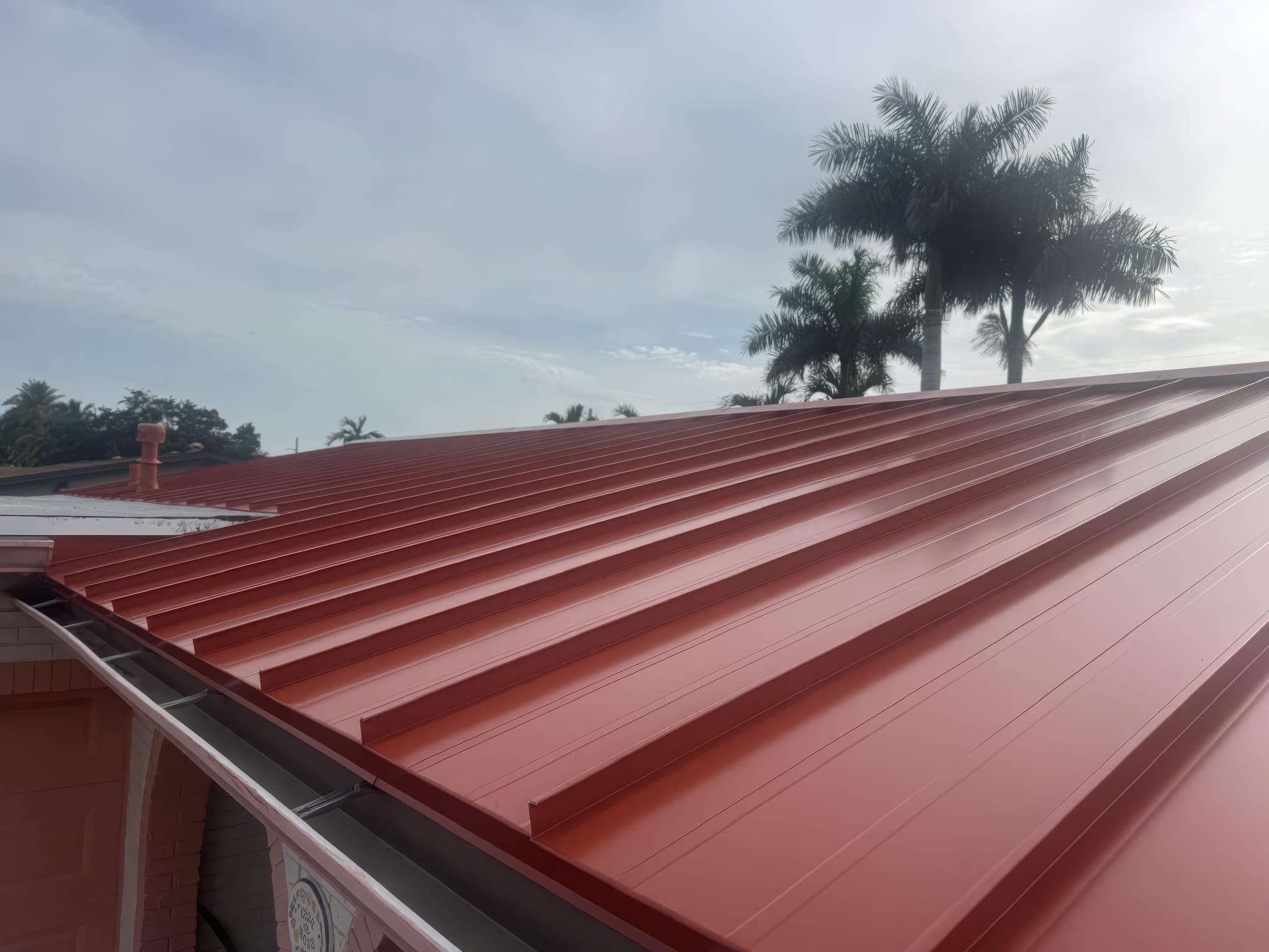 New red standing seam metal roof seen from the ridge