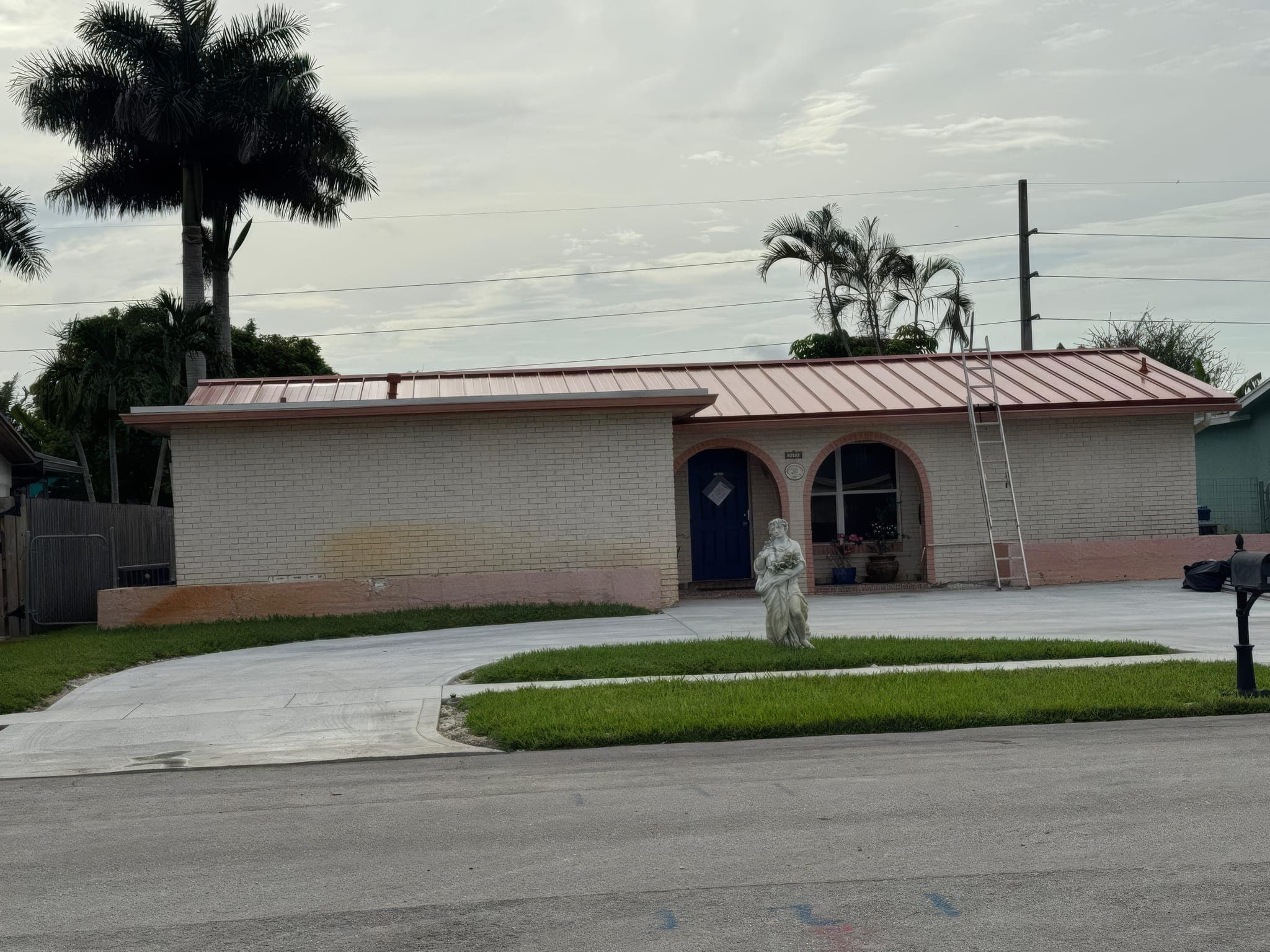 Front of the single-story Sunrise home with its new red metal roof