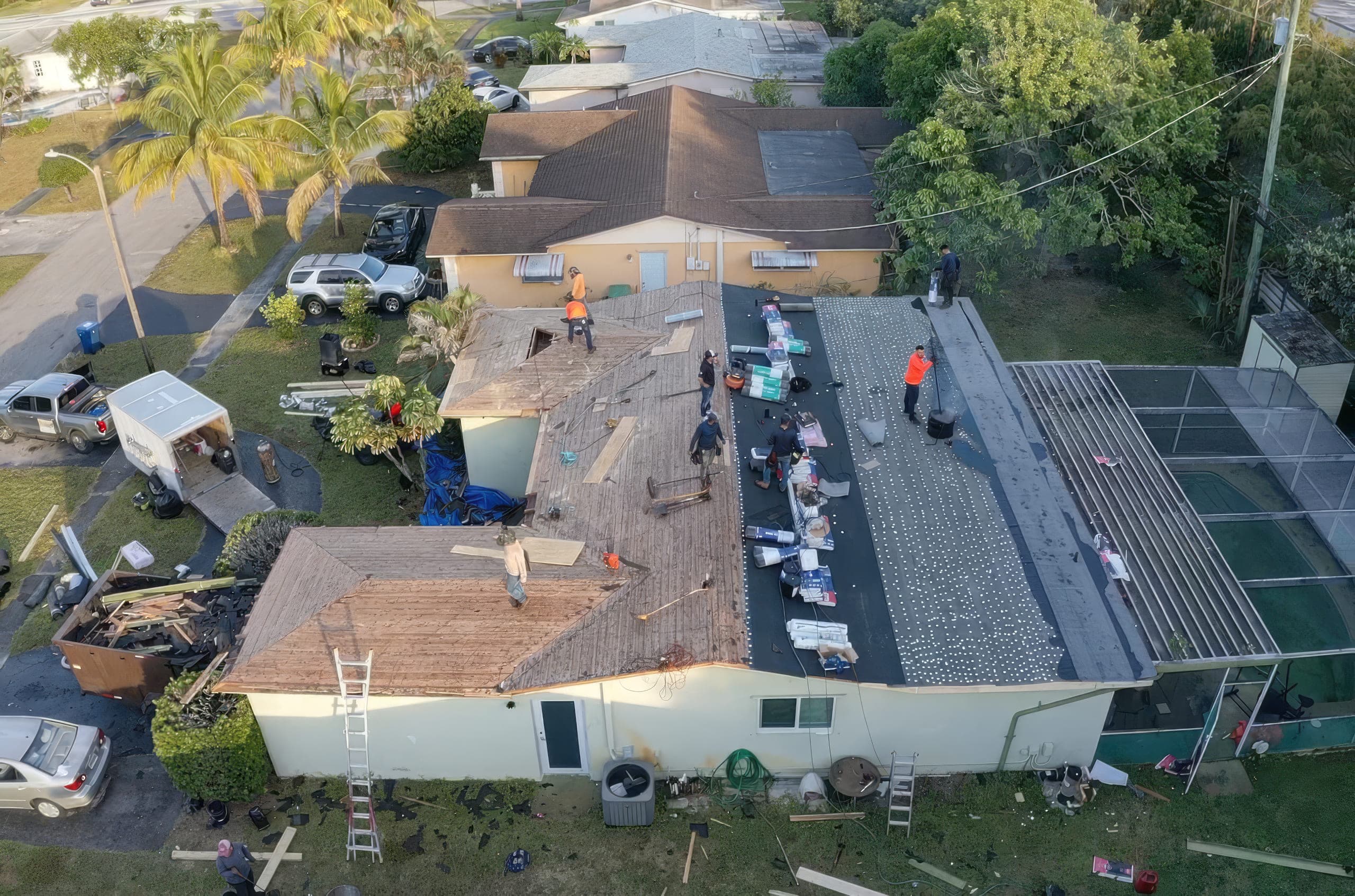 Tear-off in progress with new decking and underlayment going down on the pitched slopes