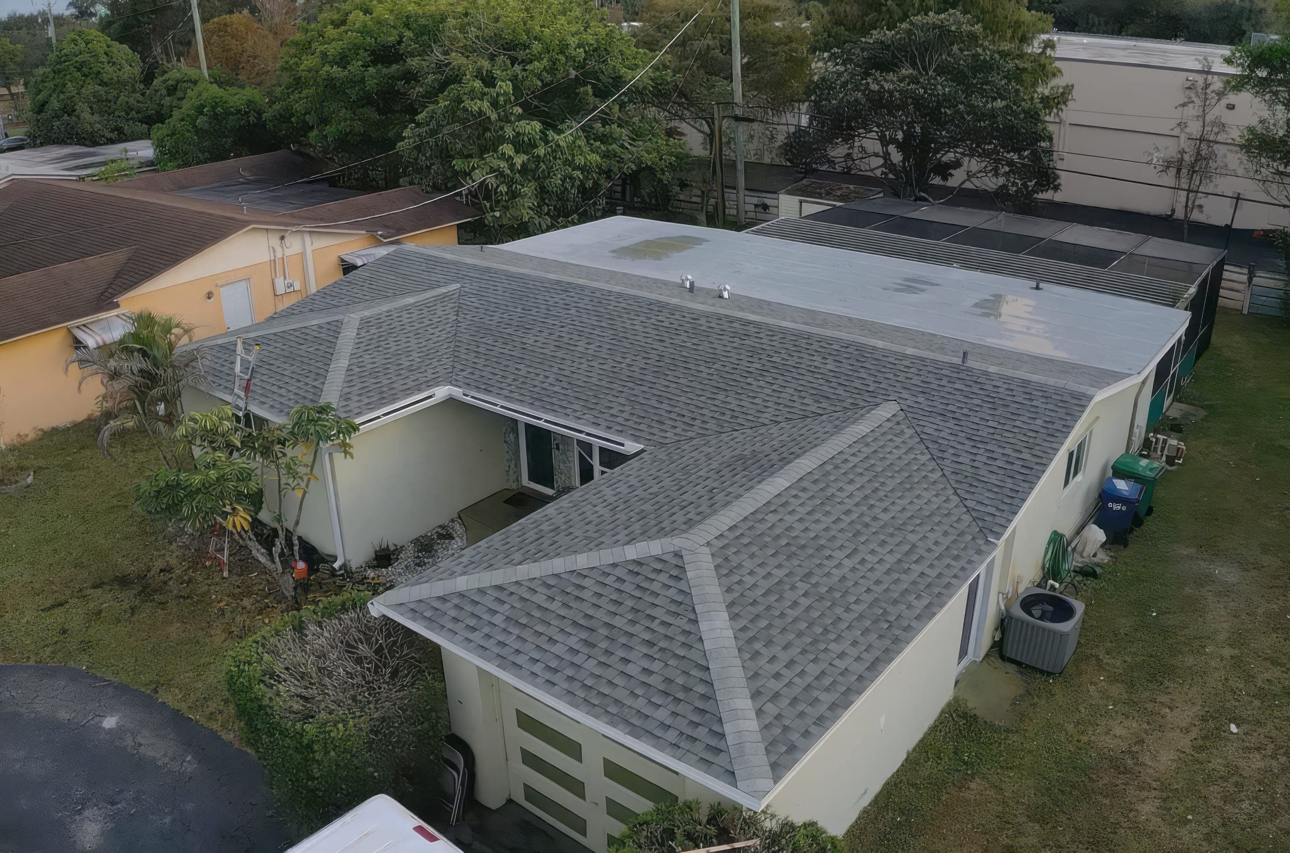 Aerial view of the finished shingle and flat roof from the front corner of the house