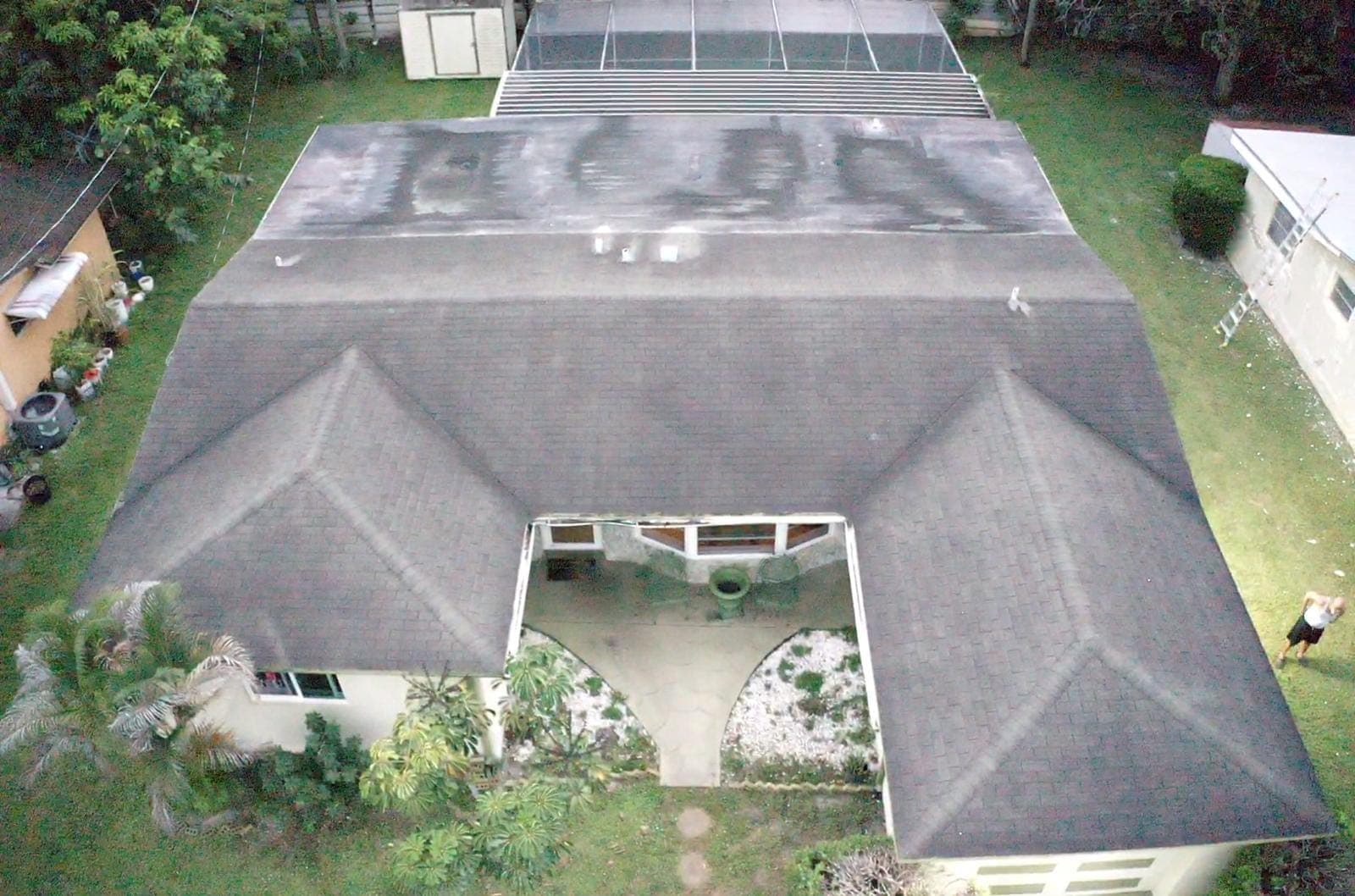 Straight-down drone view of a worn shingle roof