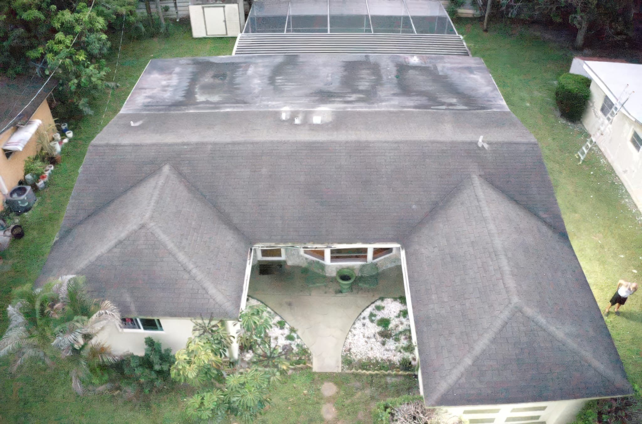 Straight-down drone view of a worn shingle roof