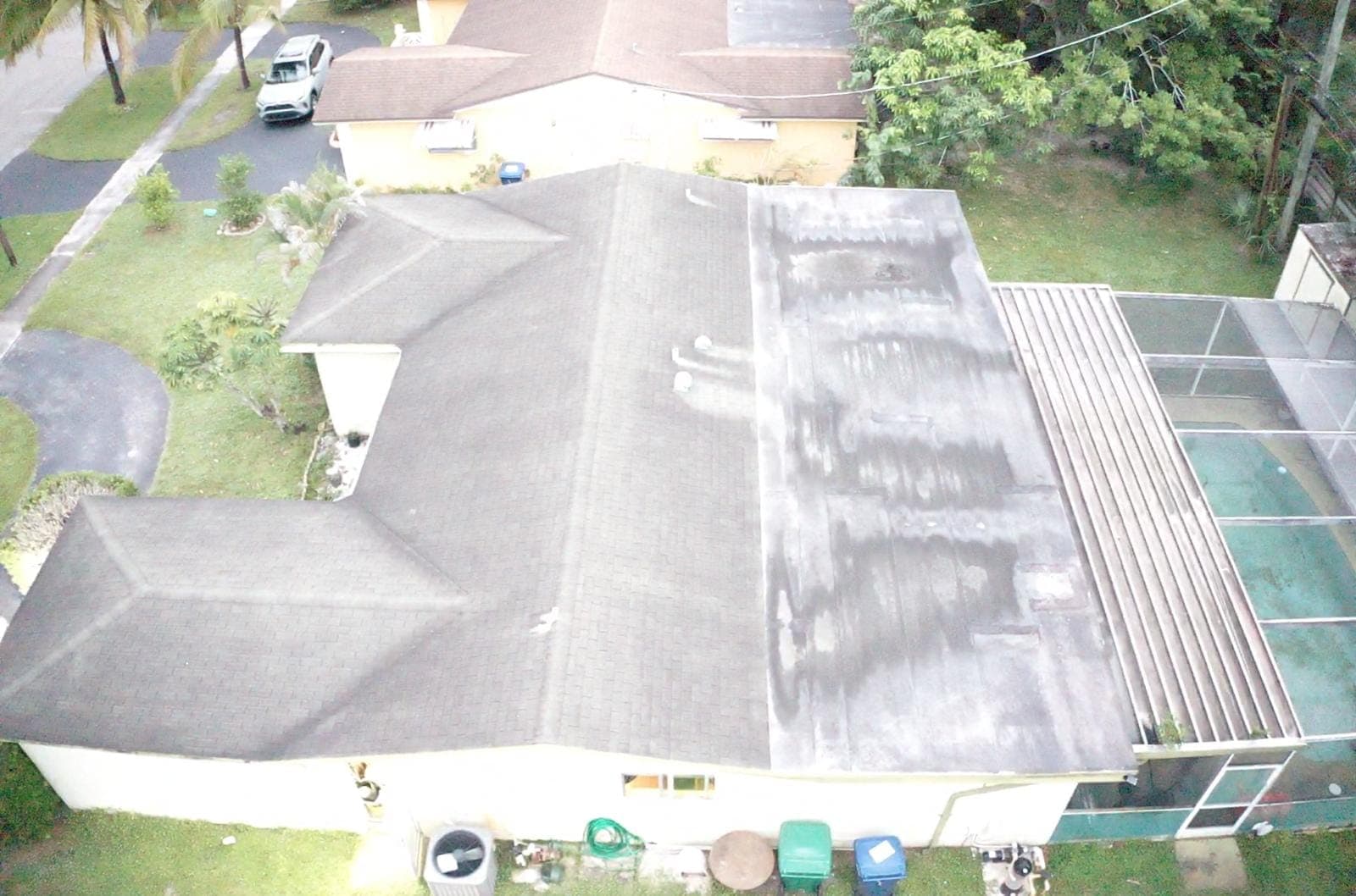 Angled drone view of a shingle roof with staining