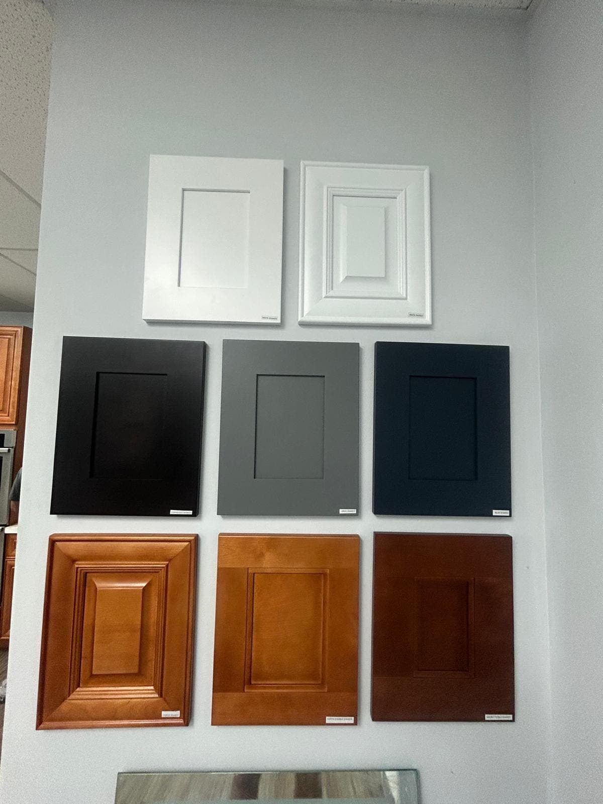 Cabinet door samples in white, grey, black and wood