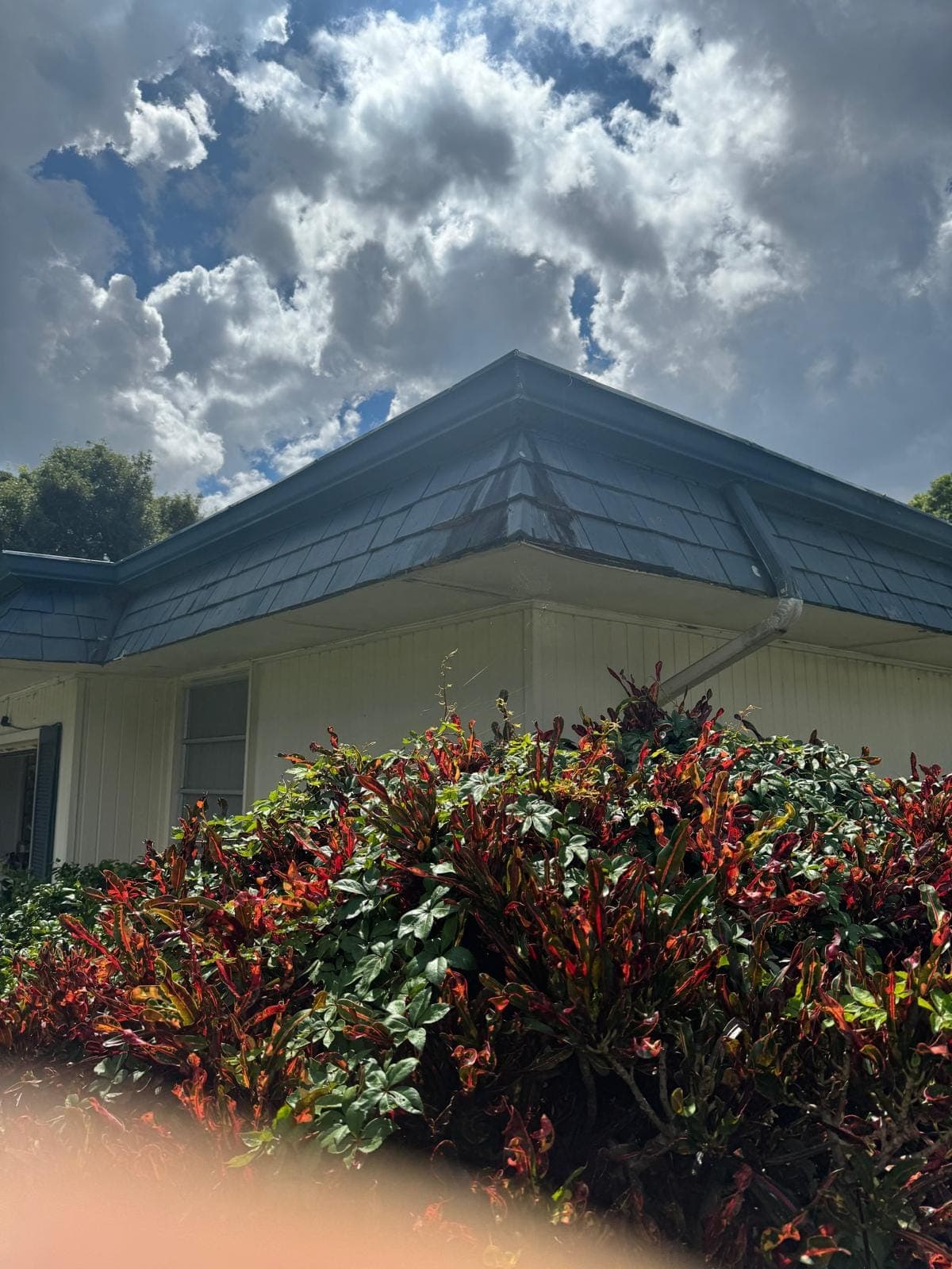 Mansard roof with a section under tarp