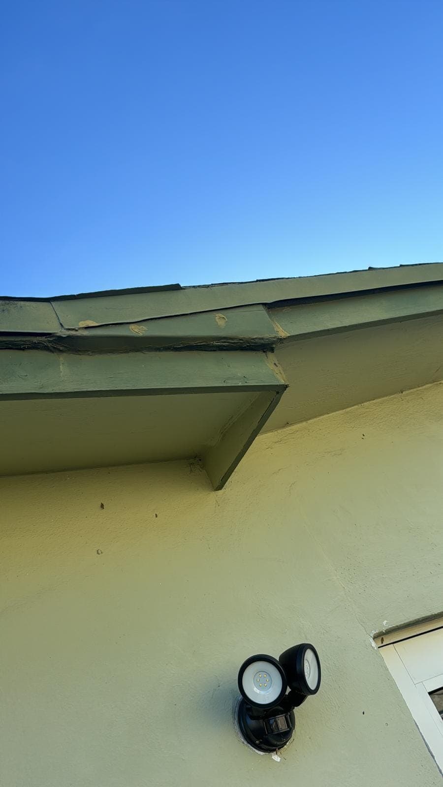Damaged fascia board at a roof corner