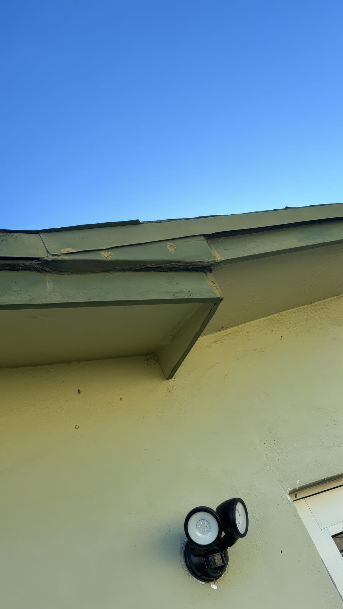 Damaged fascia board at a roof corner