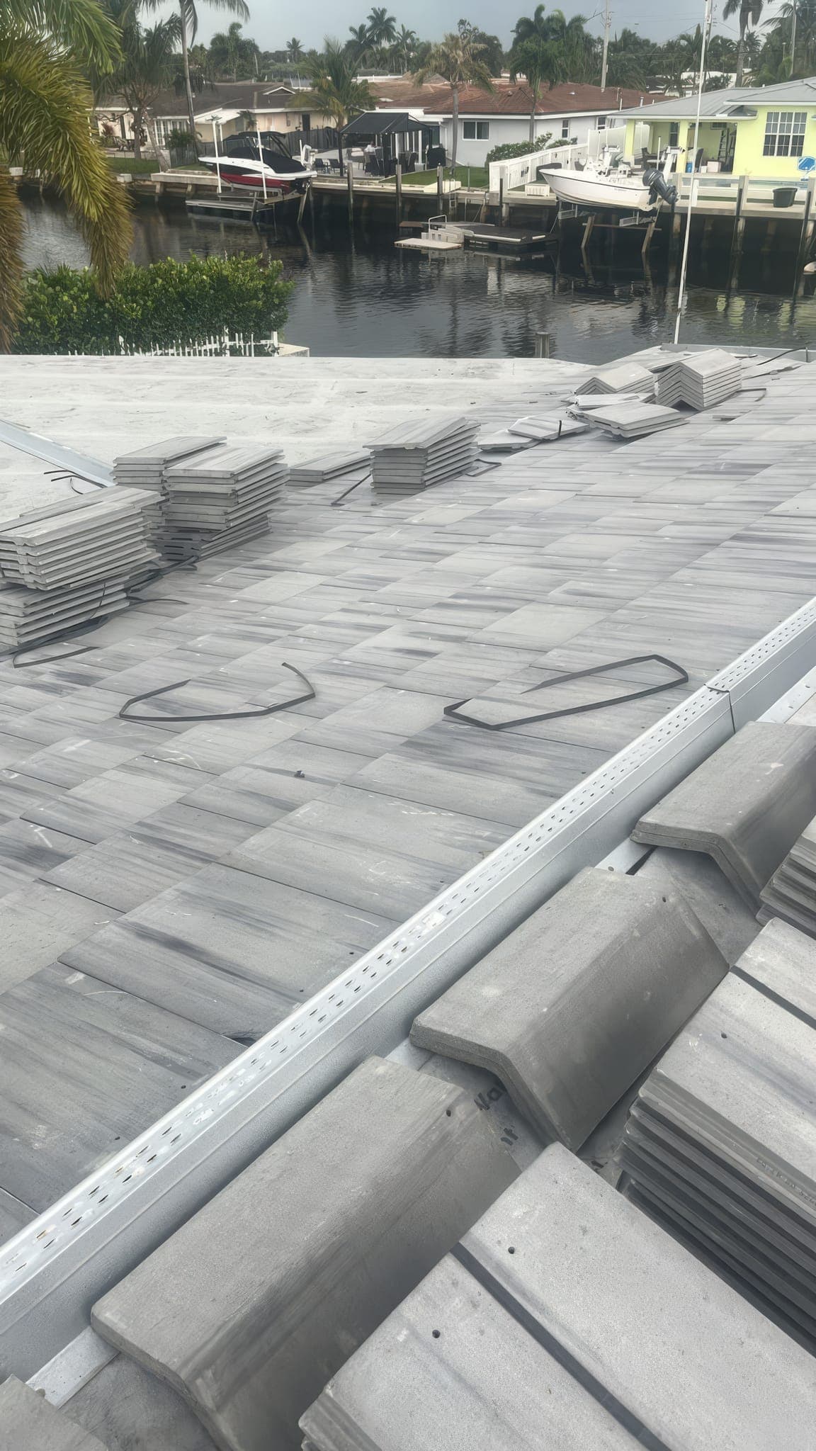 White flat tile stacked on the slope with the ridge ready for setting