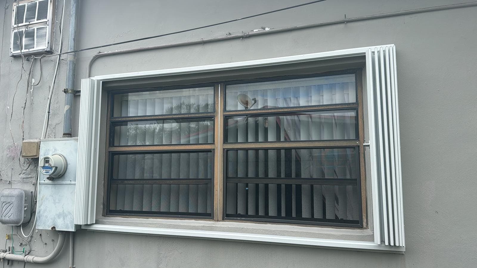 Old horizontal slider window with security bars