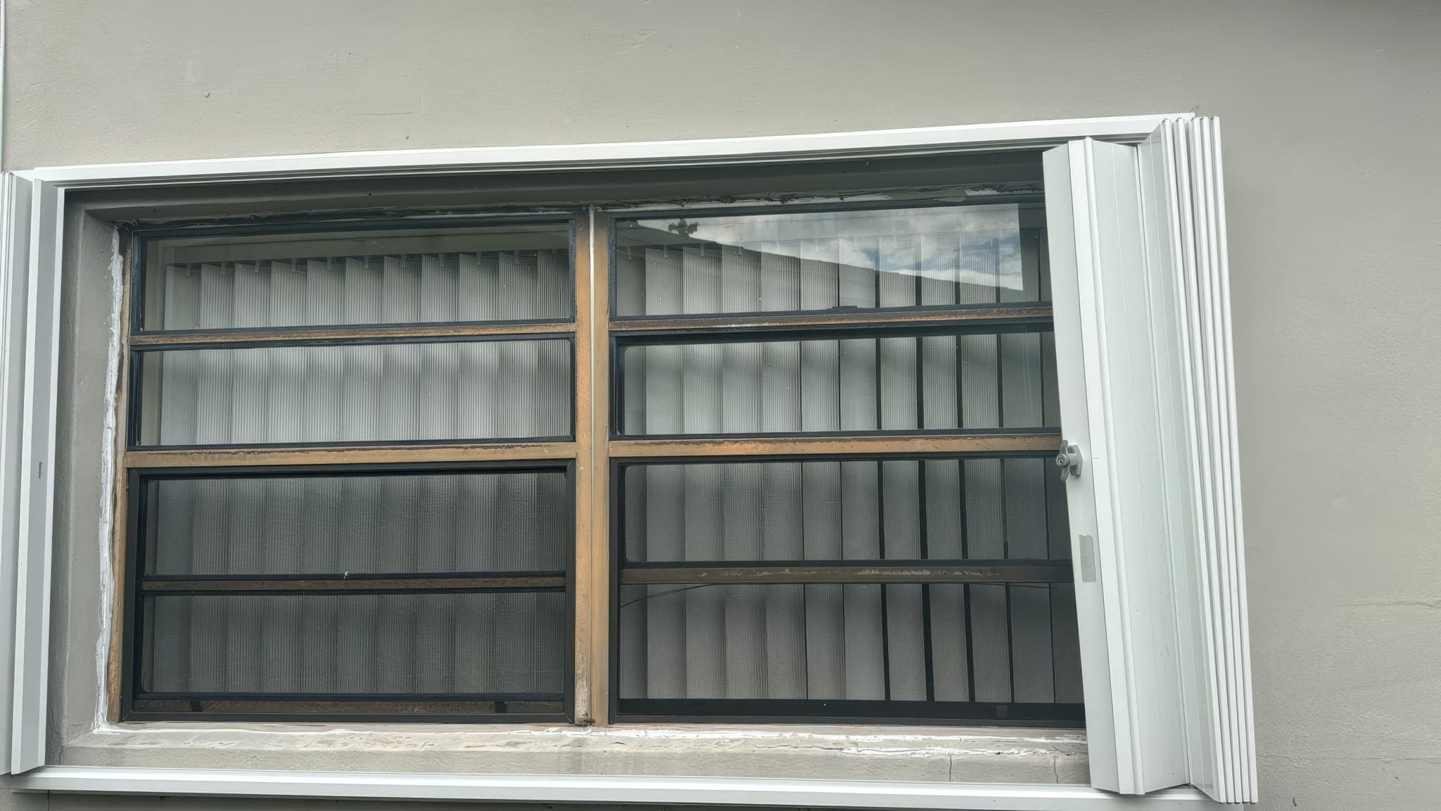 Original window with accordion shutter tracks