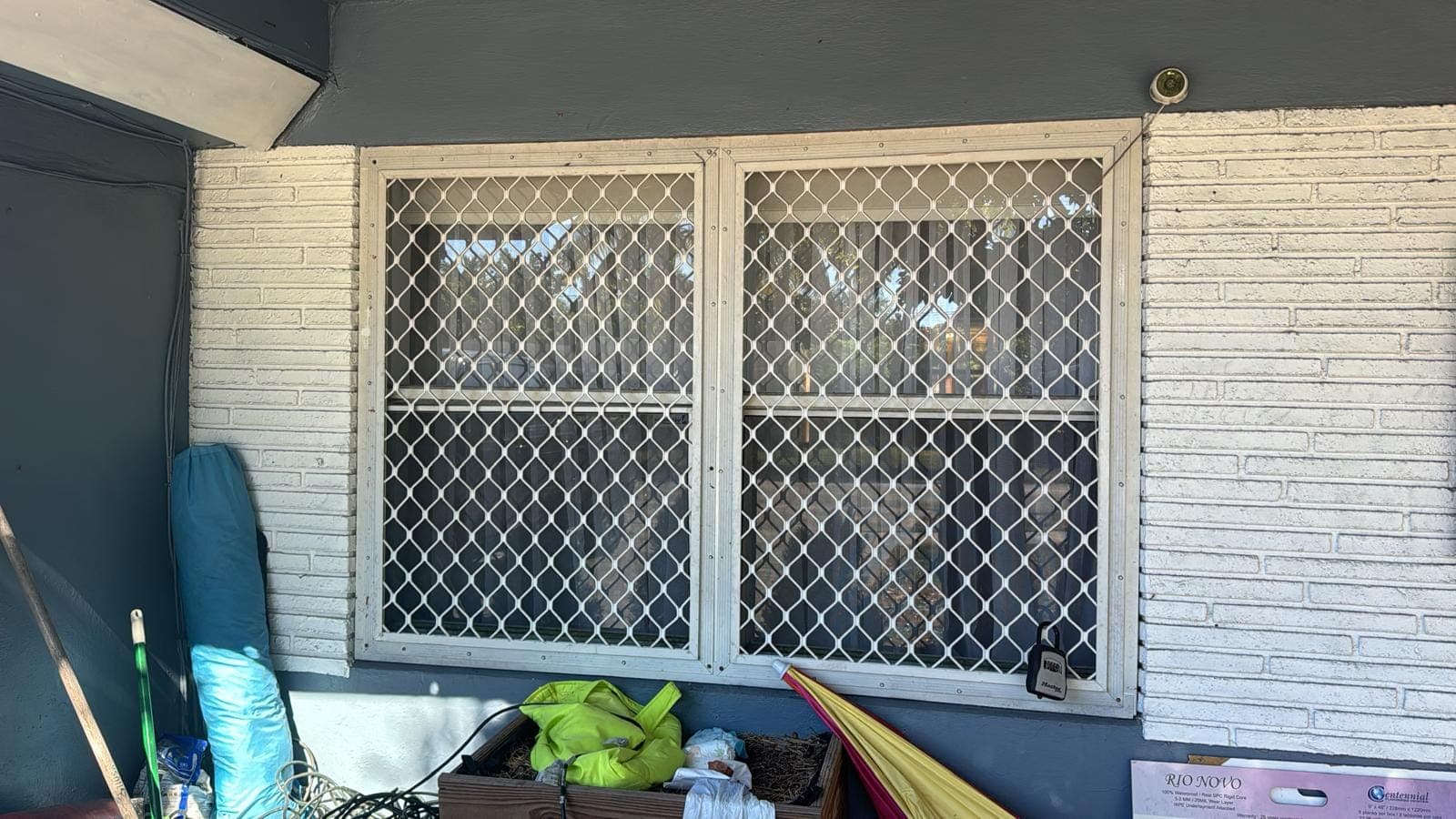 Old window with decorative security grille