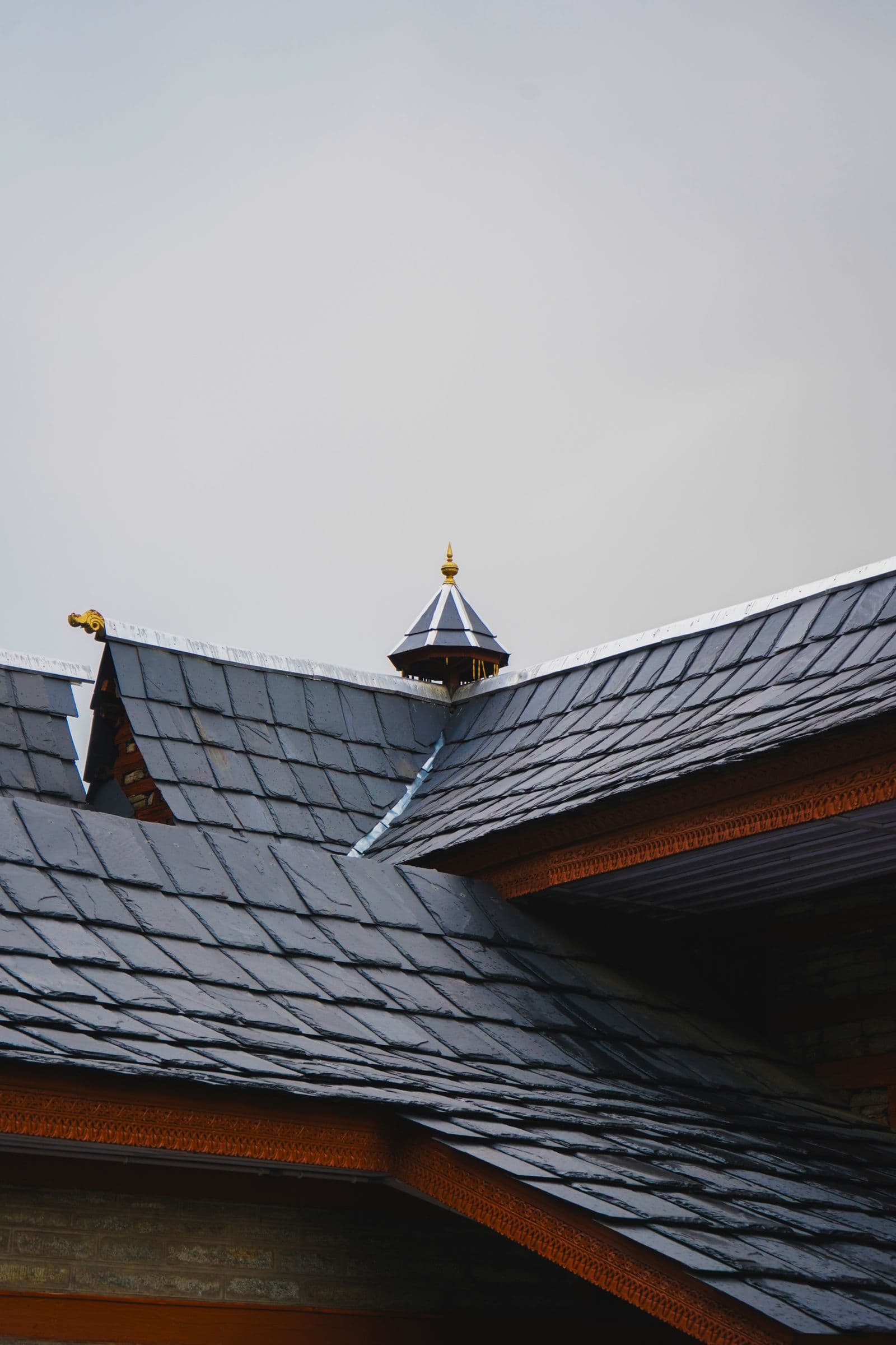 Roofer installing asphalt shingles on a new residential roof