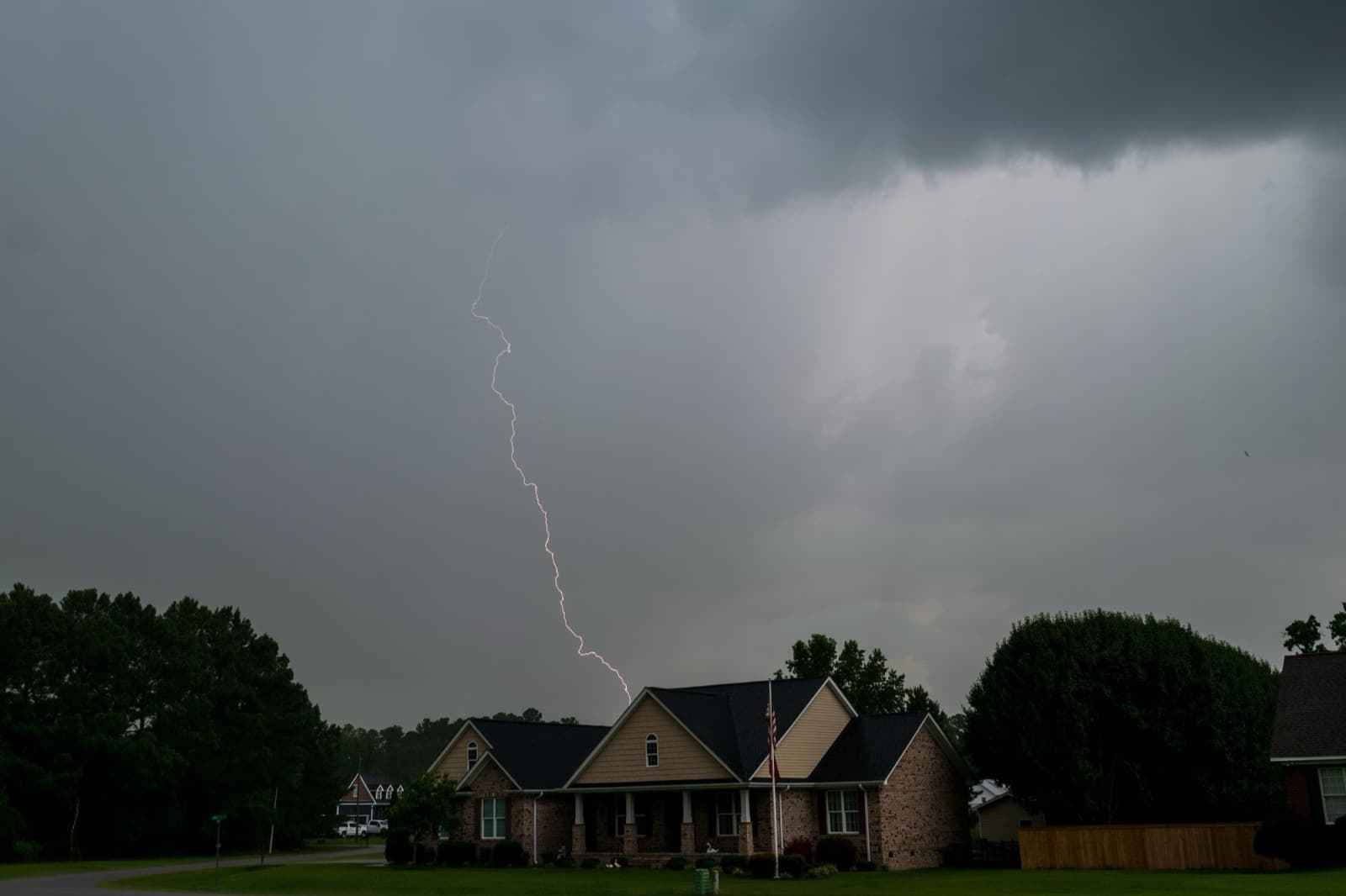 Lightning over suburban homes during a storm