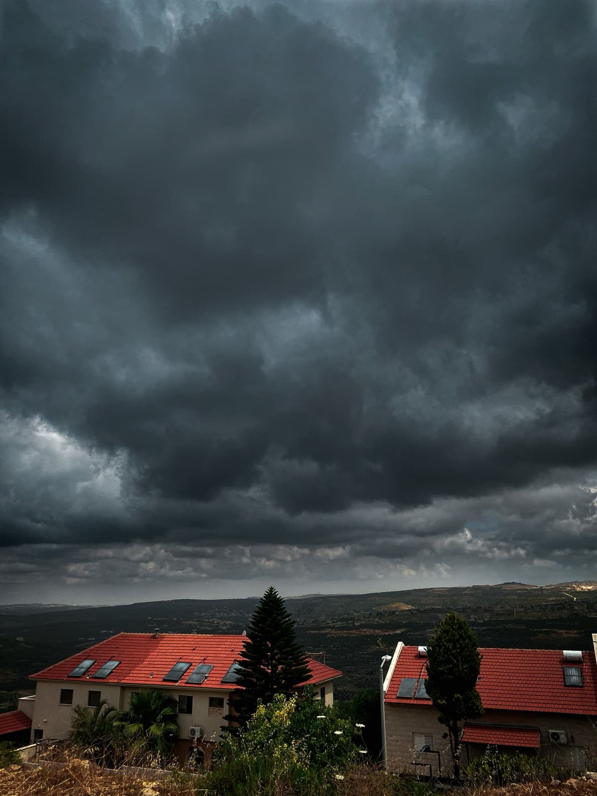 Storm clouds gathering over a suburban neighborhood